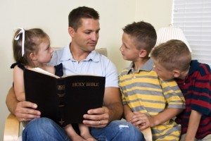 Father reading to his children